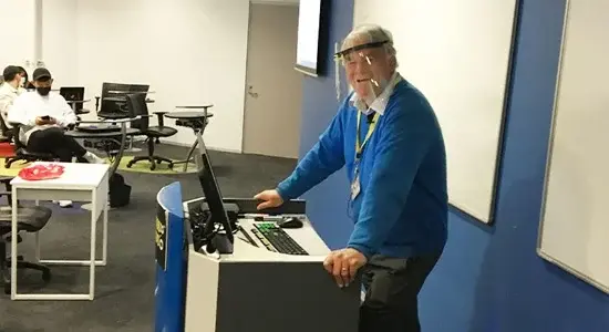 Faculty members use a face shield when conducting a lecture